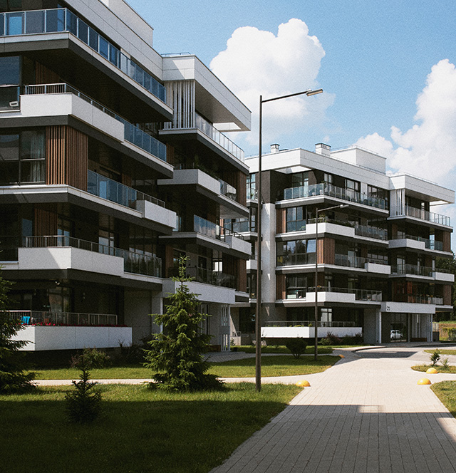 Modernes Gebäudekomplex mit Begrünung und Fußweg